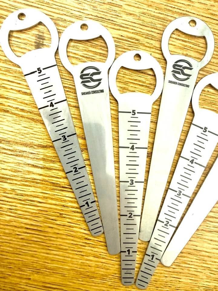 Stainless steel multi-tools standing upright with circular engraved logos